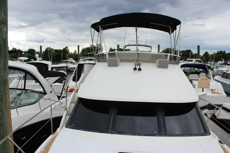 Slide: The Image of 1997 Silverton 351 Sedan yacht docked at marina under cloudy sky. - 47
