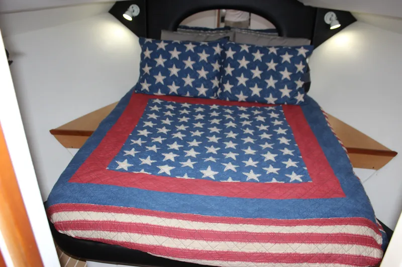 Slide: The Image of Cozy cabin bed in 1997 Silverton 351 Sedan with star-patterned bedding. - 53