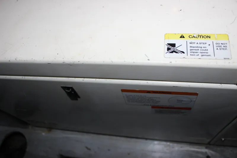 Slide: The Image of 1997 Silverton 351 Sedan generator with caution label, warning against standing on it. - 70