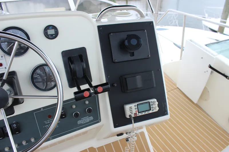Slide: The Image of 1997 Silverton 351 Sedan helm with steering wheel, gauges, and controls on teak deck. - 20