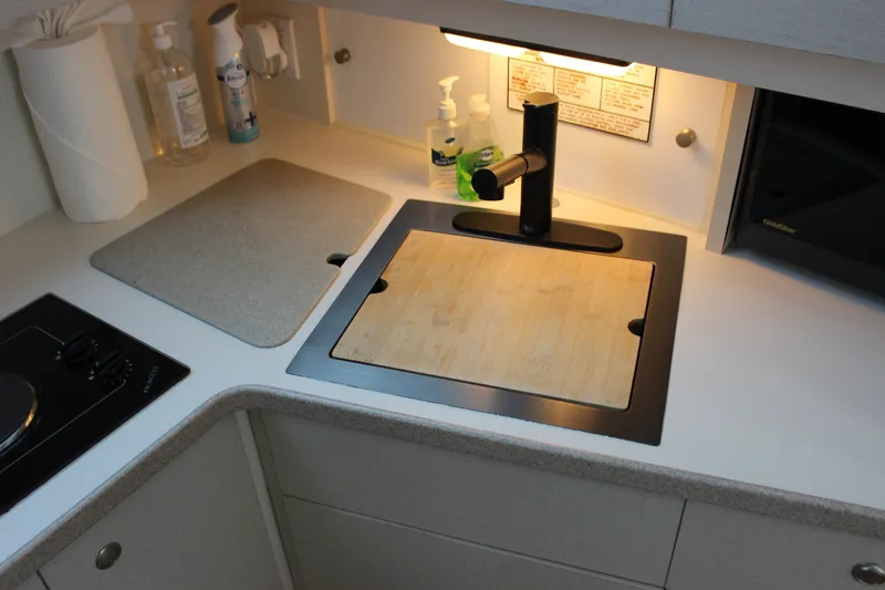 Slide: The Image of 1997 Silverton 351 Sedan kitchen area with sink, faucet, and countertop essentials. - 74