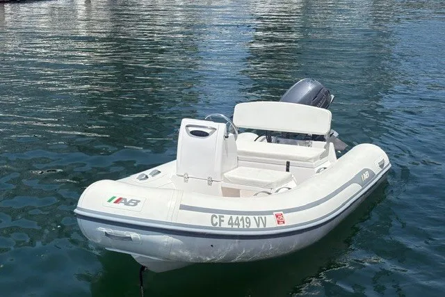 The Image of 2023 AB Inflatables Mares 11 VSX boat on calm water, featuring sleek design and outboard motor. - 1