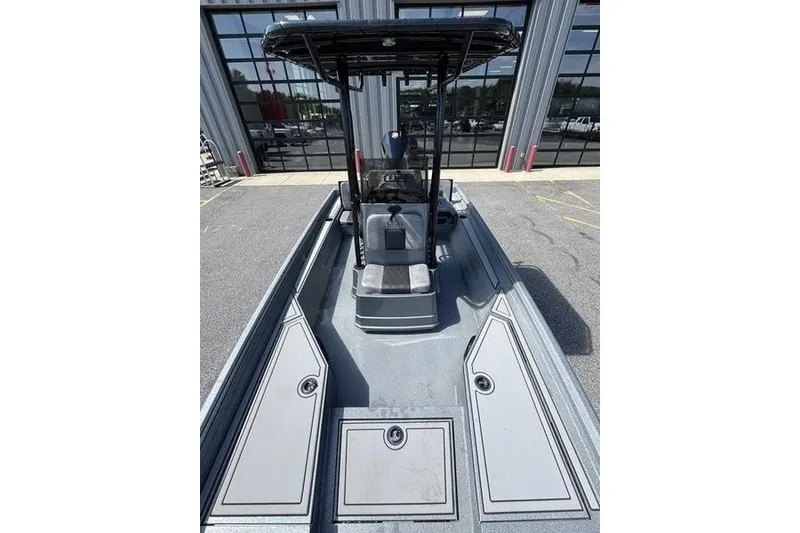 Slide: The Image of 2027 Excel 220 Bay Pro Elite boat with center console, parked outdoors. - 16