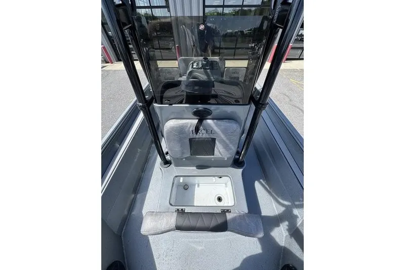 Slide: The Image of 2027 Excel 220 Bay Pro Elite boat interior with seating and storage compartment. - 24
