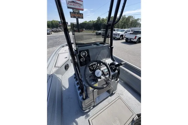 Slide: The Image of 2027 Excel 220 Bay Pro Elite boat console with steering wheel and controls. - 18
