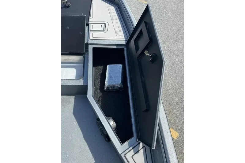 Slide: The Image of Open storage compartment in 2027 Excel 220 Bay Pro Elite boat. - 21