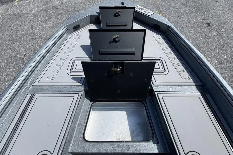Slide: The Image of 2027 Excel 220 Bay Pro Elite boat deck with open storage compartments. - 27