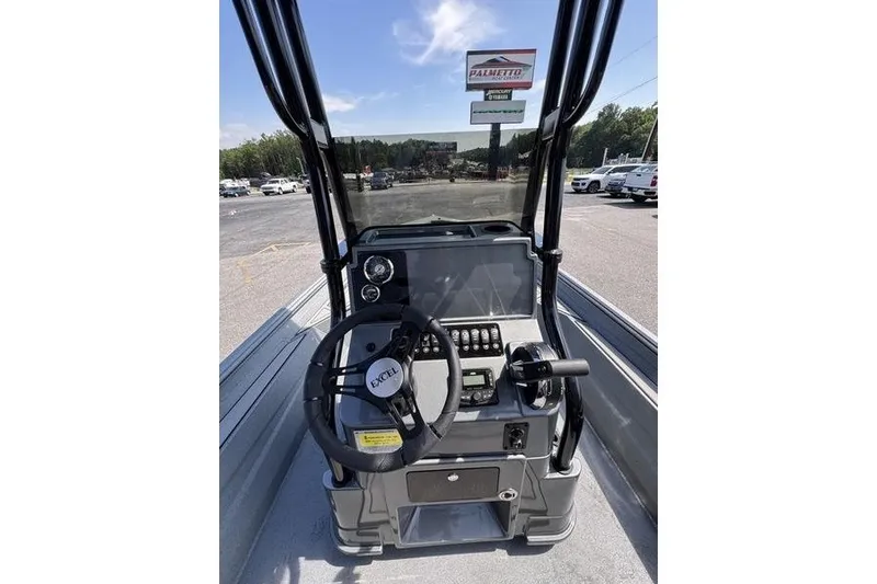 Slide: The Image of 2027 Excel 220 Bay Pro Elite boat dashboard with steering wheel and controls. - 28