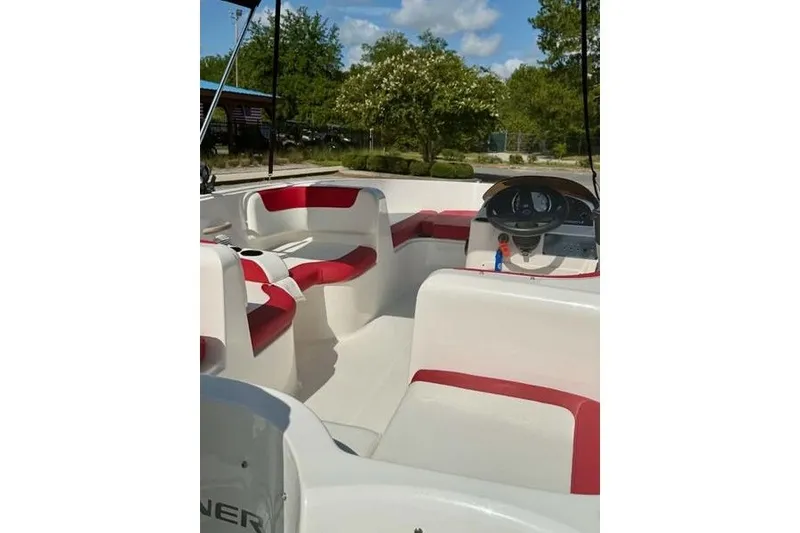 Slide: The Image of 2021 Bayliner Element E16 boat interior with red and white seating, steering console. - 10