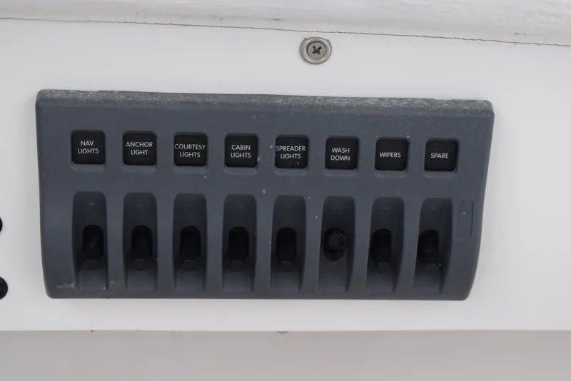 Slide: The Image of Control panel of a 2023 NorthCoast 215 HT boat with labeled switches. - 16
