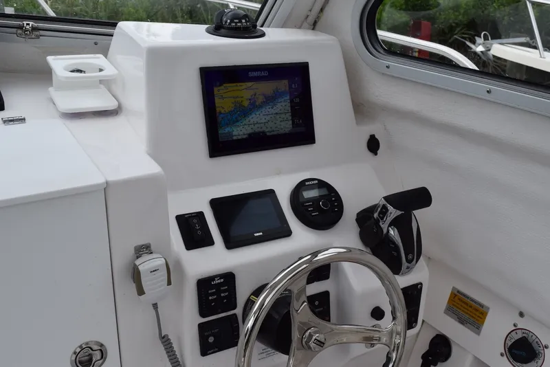 Slide: The Image of 2023 NorthCoast 215 HT boat dashboard with navigation system and steering wheel. - 15