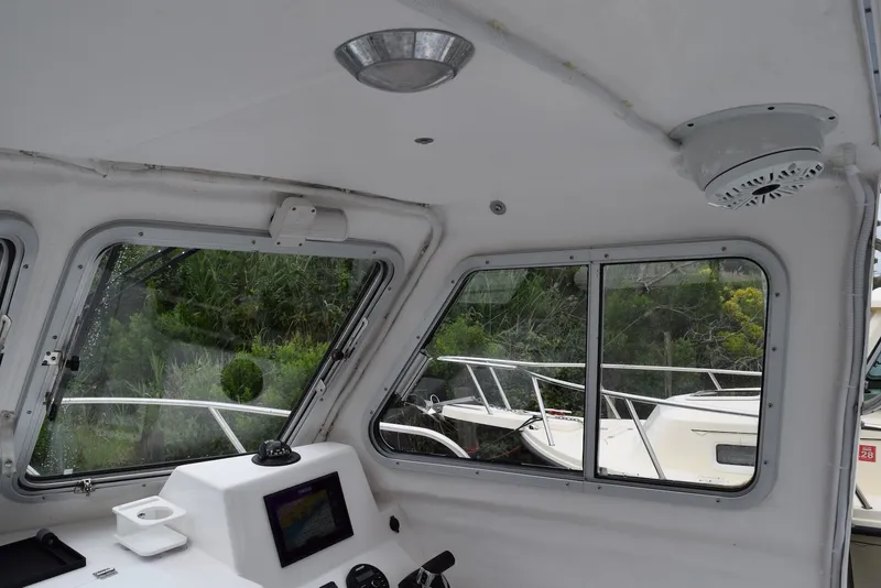 Slide: The Image of Interior view of 2023 NorthCoast 215 HT boat cabin with windows and control panel. - 21