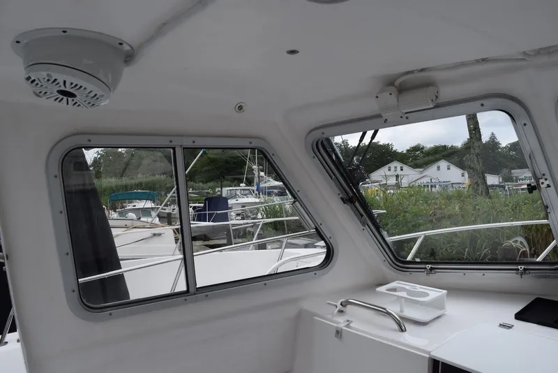 Slide: The Image of Interior view of 2023 NorthCoast 215 HT boat with windows and outdoor scenery. - 20