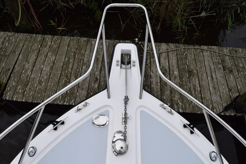 Slide: The Image of Bow view of 2023 NorthCoast 215 HT boat docked by wooden pier. - 23