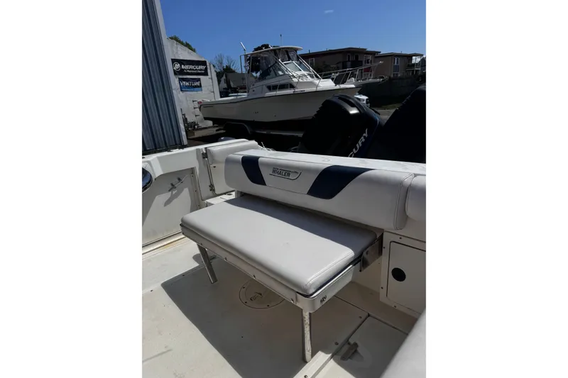 Slide: The Image of 2001 Boston Whaler 23 Outrage boat interior with seating and Mercury engine. - 7