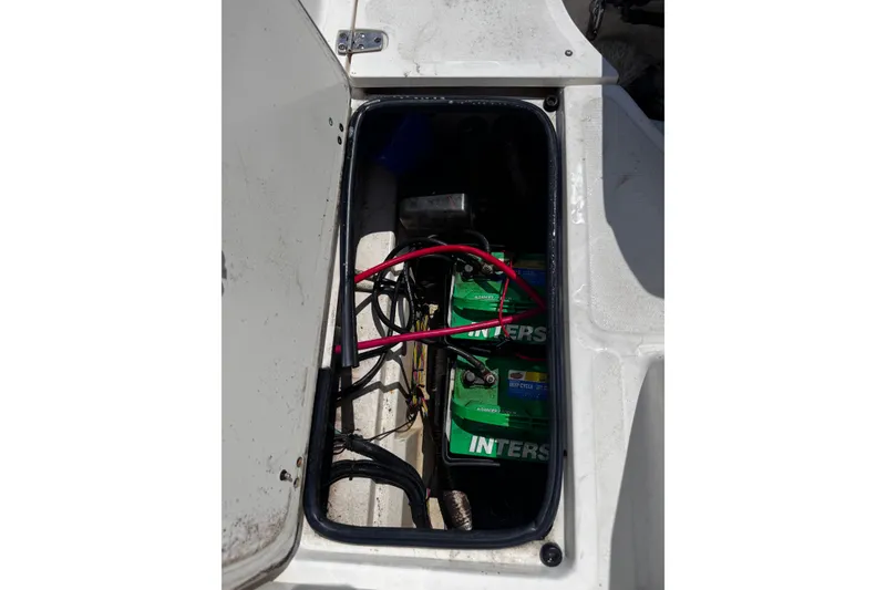 Slide: The Image of Battery compartment of a 2001 Boston Whaler 23 Outrage boat with visible wiring. - 18
