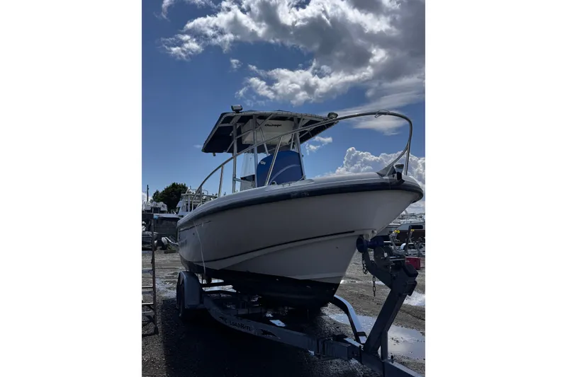 Slide: The Image of 2001 Boston Whaler 23 Outrage boat on trailer under cloudy sky. - 4