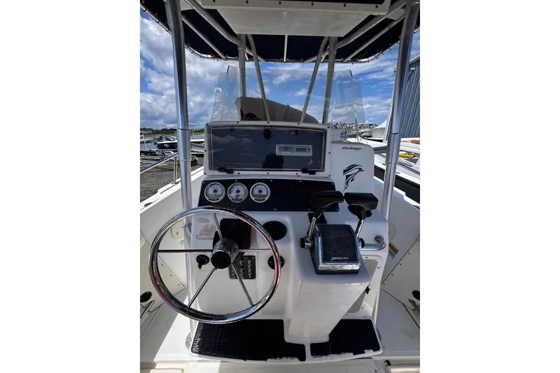 Slide: The Image of Center console of a 2001 Boston Whaler 23 Outrage boat with steering wheel and controls. - 9