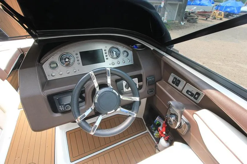 Slide: The Image of The image shows the cockpit of a 2016 Regal 2800 Bowrider with a modern dashboard. - 16