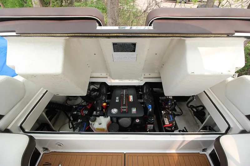 Slide: The Image of The engine compartment of a 2016 Regal 2800 Bowrider with an open hatch and visible engine. - 25