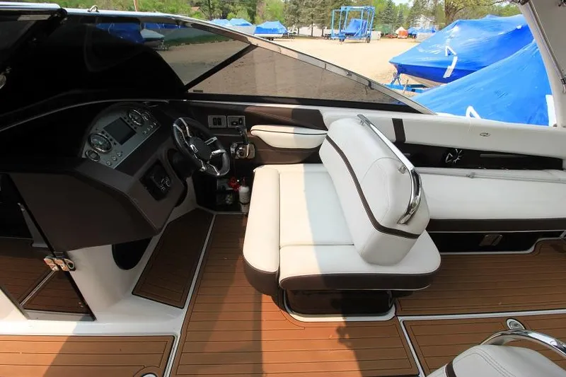 Slide: The Image of The image shows the cockpit of a 2016 Regal 2800 Bowrider with white seats and wood flooring. - 14