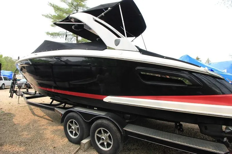 Slide: The Image of A black 2016 Regal 2800 Bowrider on a trailer, featuring a black canopy. - 3