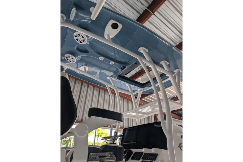 Slide: The Image of 2027 Tidewater 2410 Bay Max boat interior with blue ceiling and white framework. - 24