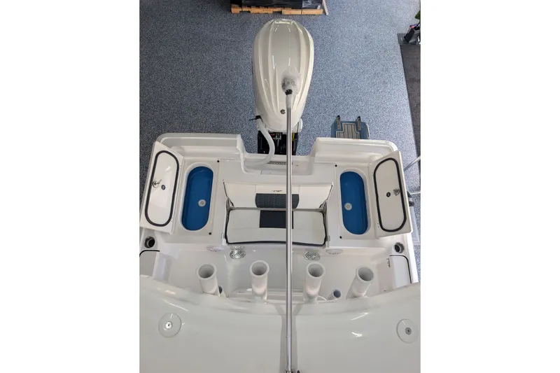Slide: The Image of 2027 Tidewater 2410 Bay Max boat interior with storage compartments and motor. - 19