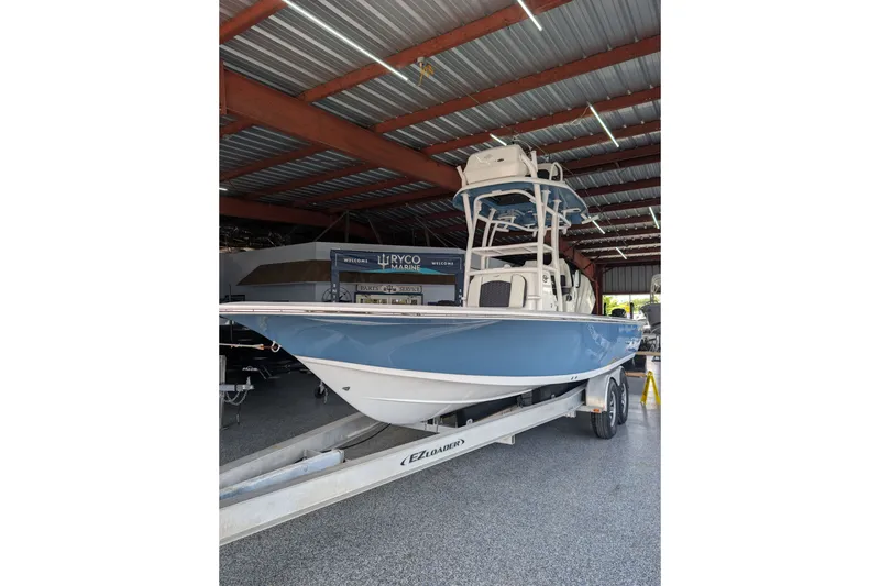 The Image of 2027 Tidewater 2410 Bay Max boat on trailer in indoor showroom. - 5