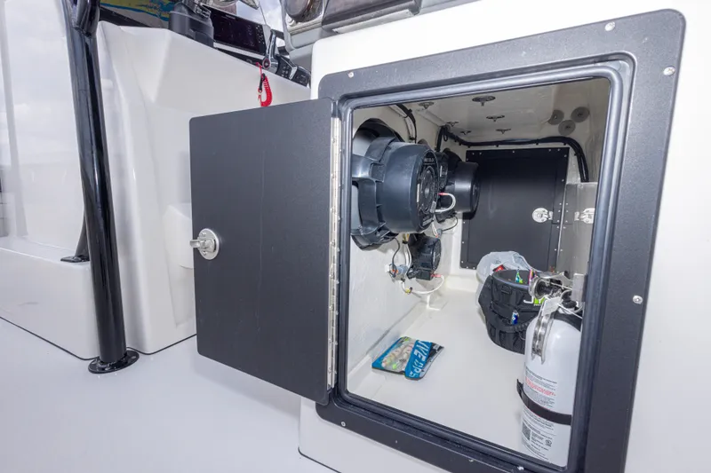 Slide: The Image of Open storage compartment on Calcutta 263 boat, showcasing interior equipment and fire extinguisher. - 67