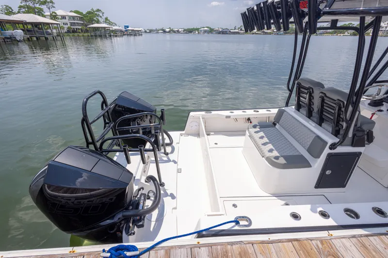 Slide: The Image of Calcutta 263 boat, 2026 model, docked with dual outboard engines, scenic waterfront view. - 33