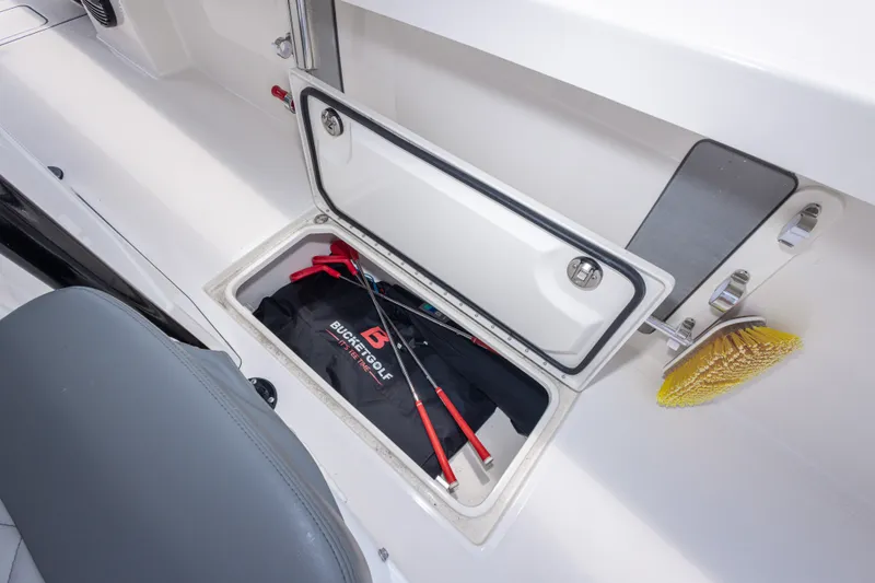 Slide: The Image of Storage compartment on Calcutta 263 boat, featuring golf equipment and cleaning brush, 2026 model. - 47