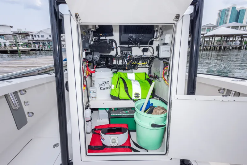 Slide: The Image of Storage compartment of 2026 Calcutta 263 boat with equipment and supplies, dockside view. - 36