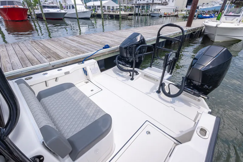 Slide: The Image of Calcutta 263 boat, 2026 model, docked with dual outboard motors and cushioned seating. - 32