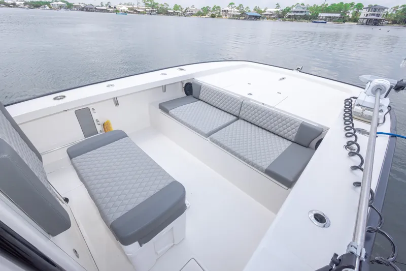 Slide: The Image of Spacious seating area on 2026 Calcutta 263 boat with quilted cushions, docked by serene waters. - 35
