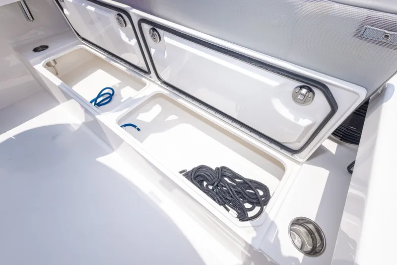 Slide: The Image of Storage compartments on a 2026 Calcutta 263 boat, featuring ropes and secure latches. - 39