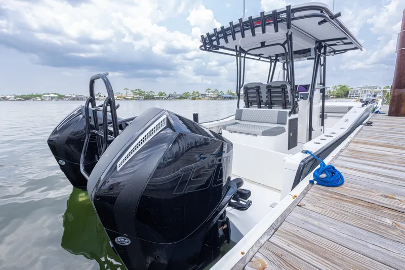 Slide: The Image of 2026 Calcutta 263 boat docked, featuring dual outboard engines and spacious seating. - 75