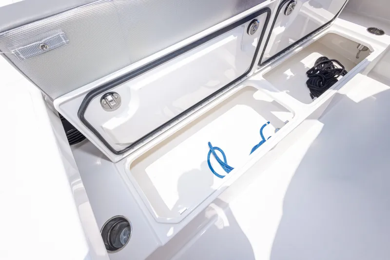 Slide: The Image of Open storage compartments on a 2026 Calcutta 263 boat, featuring ropes and sleek design. - 40