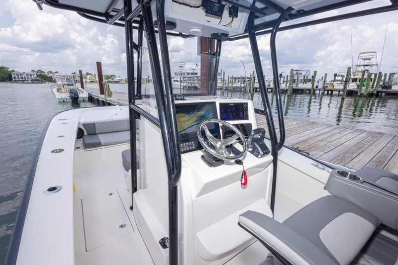 Slide: The Image of 2026 Calcutta 263 boat interior with modern helm and dockside view. - 63