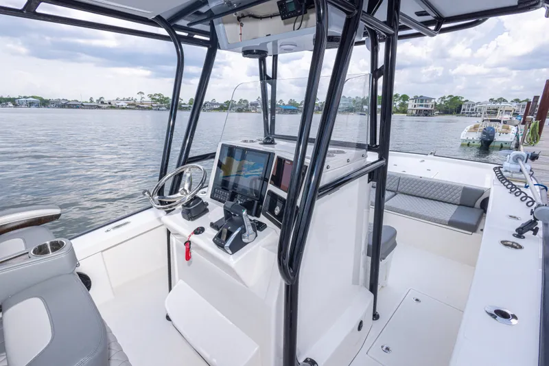 Slide: The Image of Modern 2026 Calcutta 263 boat interior with steering console and seating, docked by a scenic waterfront. - 66