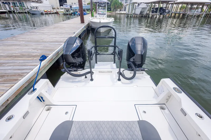 Slide: The Image of 2026 Calcutta 263 boat docked, featuring dual outboard motors and spacious deck design. - 58