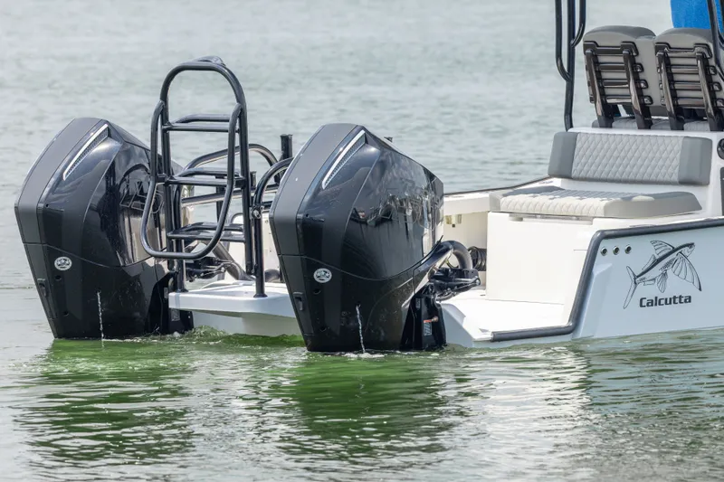 Slide: The Image of Calcutta 263 boat, 2026 model, with dual outboard motors on calm water. - 24
