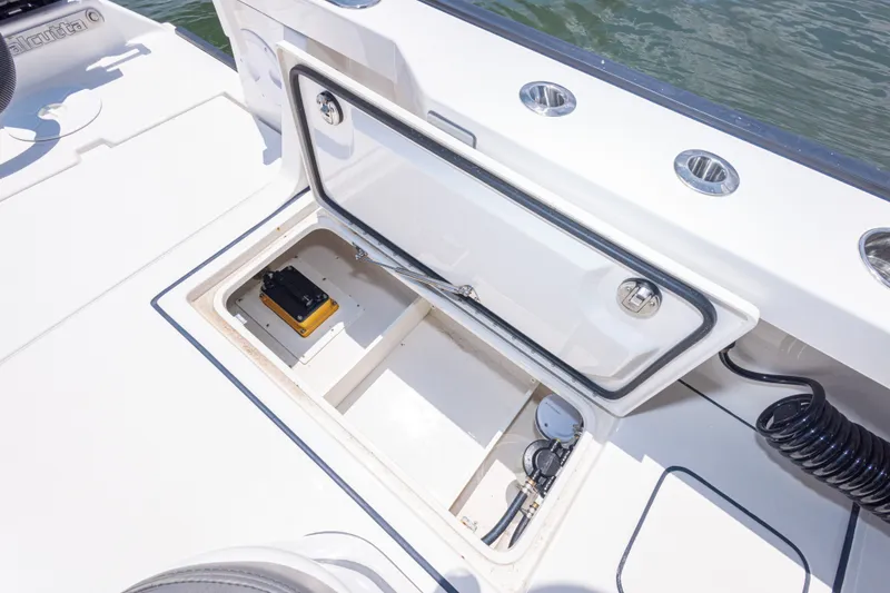 Slide: The Image of Open storage compartment on 2026 Calcutta 263 boat, featuring battery and wiring. - 62