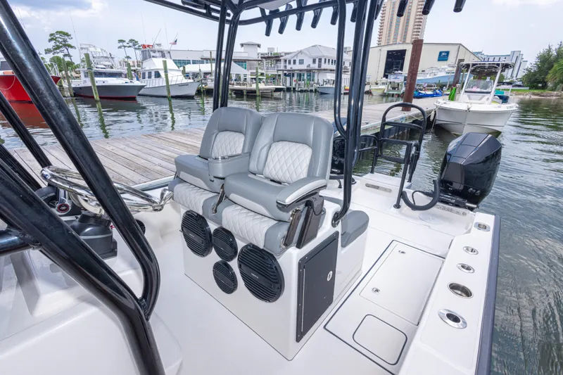 Slide: The Image of 2026 Calcutta 263 boat interior with dual seats and modern design at a marina. - 53