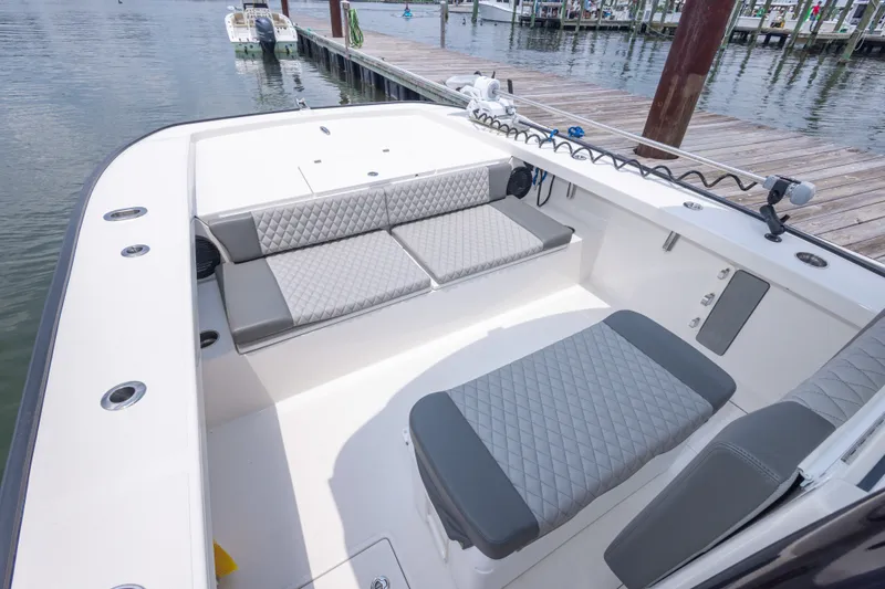 Slide: The Image of Modern Calcutta 263 boat interior with quilted seating, docked at a marina, 2026 model. - 29