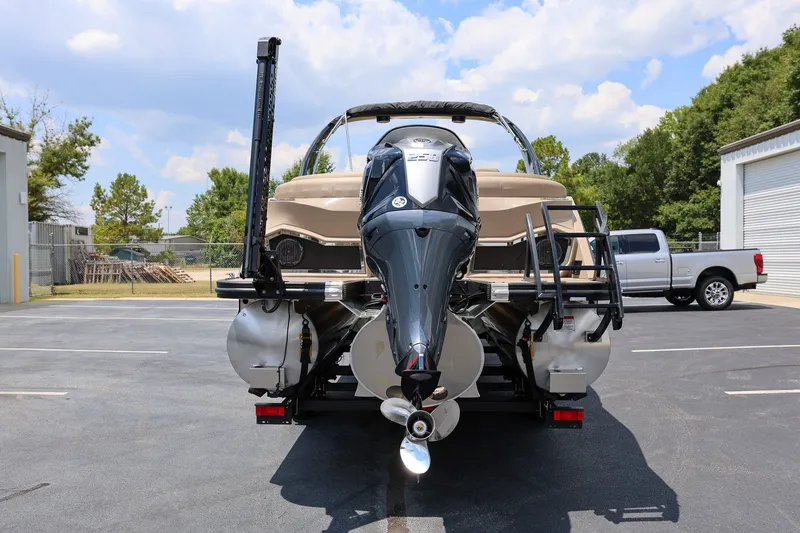 Slide: The Image of 2023 Bennington Q 25 QFBA pontoon boat with powerful outboard motor in a parking lot. - 3