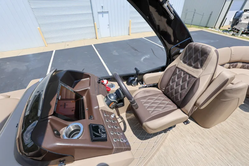 Slide: The Image of 2023 Bennington Q 25 QFBA boat interior with luxurious captain's chair and control panel. - 12