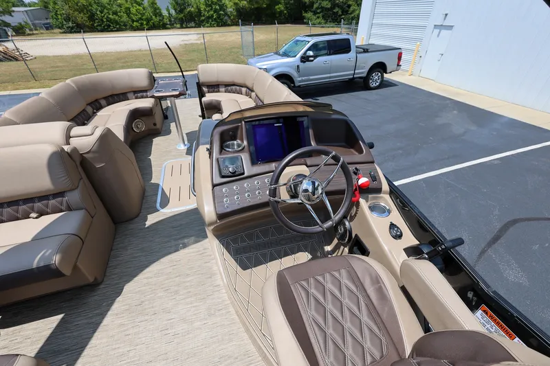 Slide: The Image of 2023 Bennington Q 25 QFBA pontoon boat interior with luxurious seating and modern helm. - 13