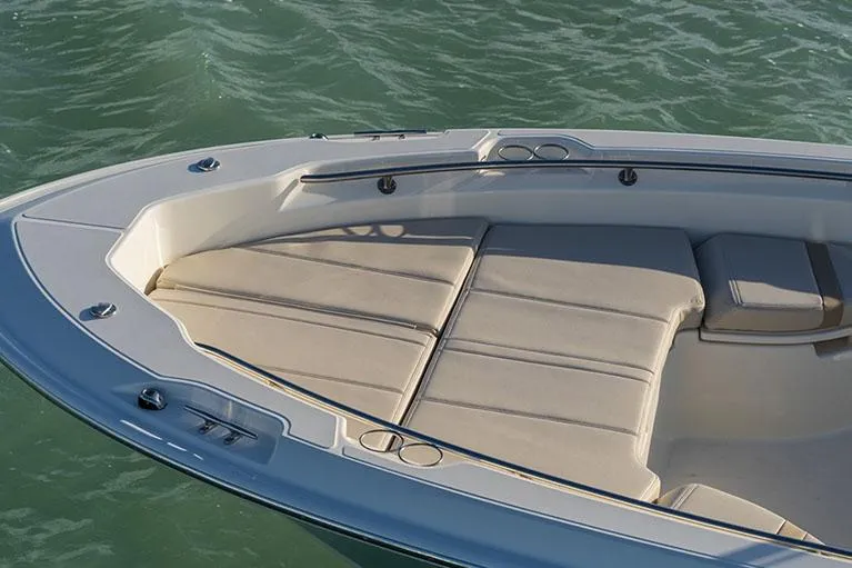 Slide: The Image of Manufacturer Provided Image: 2026 Boston Whaler 250 Dauntless boat with cushioned seating on calm water. - 5