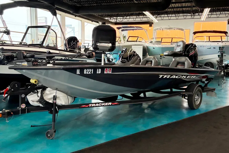 The Image of 2022 Tracker Pro Team 190 TX boat displayed in showroom with trailer. - 0
